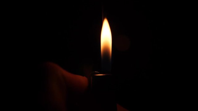 Close up shot of turning on a lighter in slow motion.