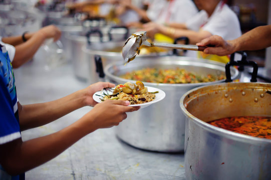 Homeless People And Hungry People Line Up, Asking For Free Food From Volunteers.