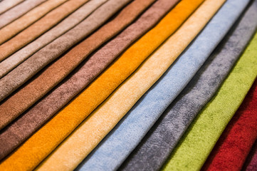 Colorful and bright fabric samples of furniture and clothing upholstery. Close-up of a palette of...