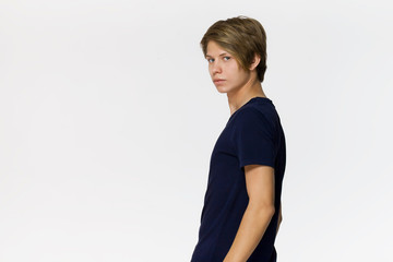 Cheerful smiling teenager in blue t-shirt against white background studio shot, isolated