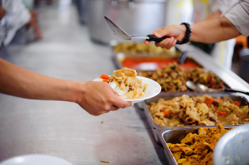 The hands of the poor waiting to receive free food: food distribution