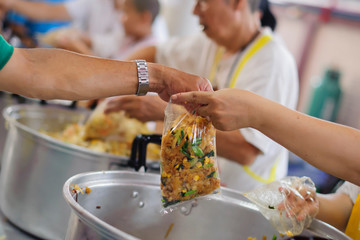 The hands of the poor waiting to receive free food: food distribution