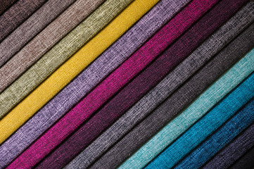 Colorful and bright fabric samples of furniture and clothing upholstery. Close-up of a palette of...