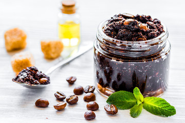 Spa concept with natural coffee scrub and oil on white background