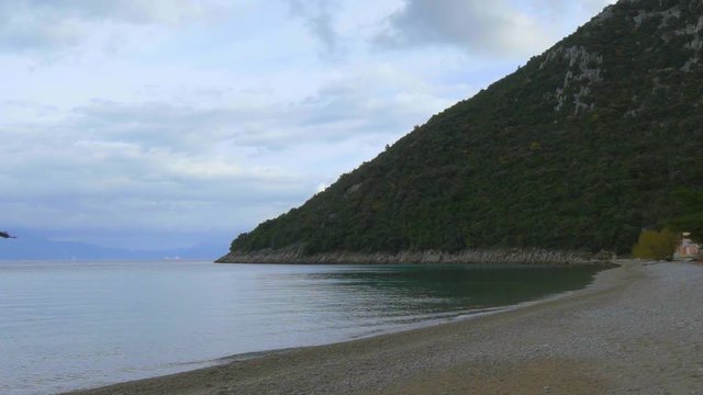 Beautiful landscape of Divna beach and a drone flying over the waters. Cres Island. Croatia. Flat plane. Slow motion