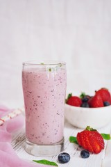 Homemade Strawberry blueberry Smoothie in a tall glass, selective focus