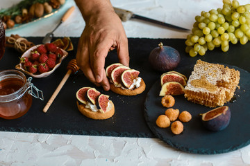 Toasts of cheese, figs and honey on whole-grain crispy bread. Close up. concept of Italian cuisine