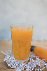 Freshly squeezed sweet orange juice with ice cubes