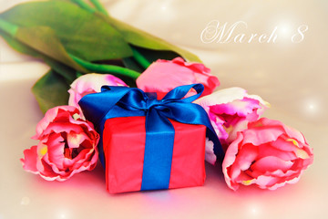 pink tulips and decorative gift box with a bow for the holiday of March 8