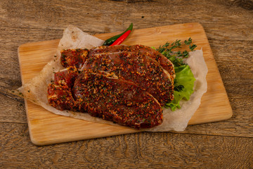 Raw marinated pork steak