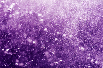 Abstract purple bokeh defocus glitter background.