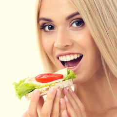 Woman in sportswear with vegetarian sandwich