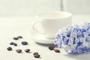 White coffee cup on a white background and flowers