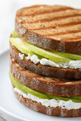 Delicious rye bread sandwich with ricotta and green Apple. Panini. Gourmet Breakfast. Selective focus
