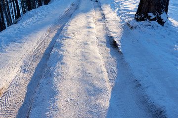 Obraz premium scenic view of empty road with snow covered landscape while snowing in winter season.