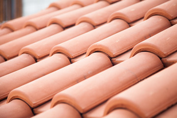Tiled roof. Texture of beautiful modern orange tile. Close up.