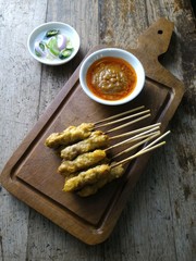 Pork Satay with Peanut Sauce and pickles which are cucumber slices and onions  in vinegar.