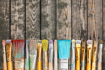 Row of artist paint brushes  on background