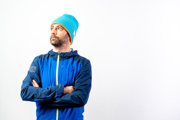 Simple portrait and white background, of a mountaineer man ready to start a challenge in nature.