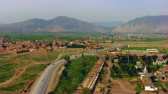 Peshawar, Pakistan, Aerial view of busy mountain pass connecting the Pak-Afghan border through white range with valley of Peshawar
