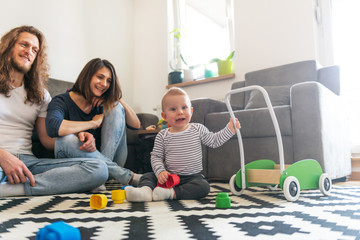 Young parents playing with baby