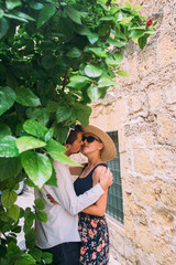 Man kissing woman on street in old city