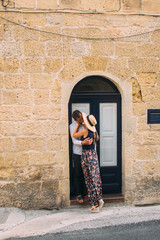 Man kissing woman on street in old city