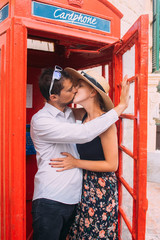 Couple kissing in red cabin, Gozo