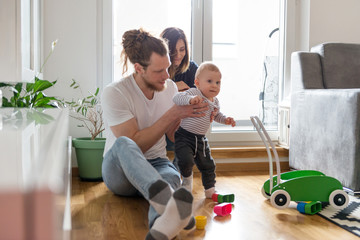 Young parents playing with baby