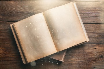 Open book on old wooden table