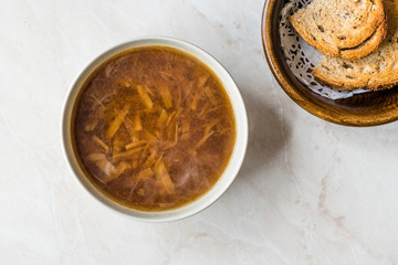 French Onion Soup with Bread on Marble Surface.