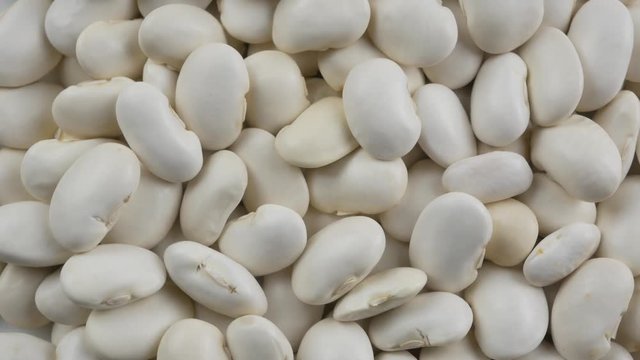Heap of white beans texture as background. Top view.