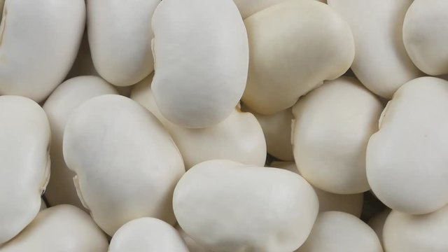 Heap of white beans texture as background. Top view.