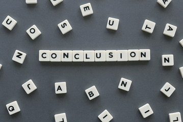 Conclusion word made of square letter word on grey background.