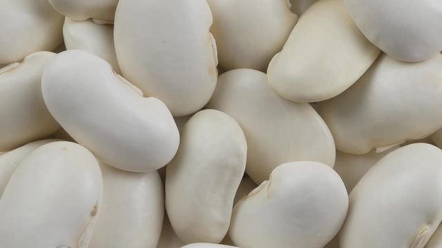 Heap of white beans texture as background. Top view.