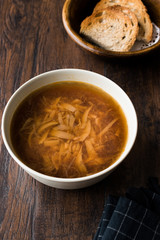 French Onion Soup with Bread on Dark Wooden Surface.