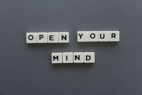 Open your mind word made of square letter word on grey background.