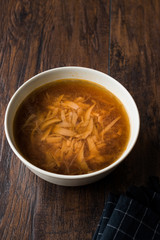 French Onion Soup with Bread on Dark Wooden Surface.