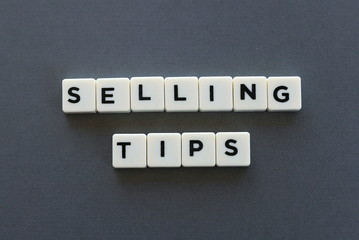 Selling tips word made of square letter word on grey background.