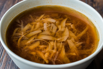 French Onion Soup with Bread on Dark Wooden Surface.