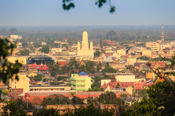 Fototapeta premium Aerial view of Phetchaburi city with Wat Mahathat Worawihan from hills at Wat Khao Bandai It viewpoint, Phetchaburi Province, Thailand