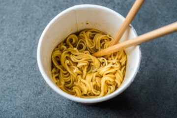 Instant Curry Flavored Ramen Noodles served with Chopsticks. in Plastic Cup