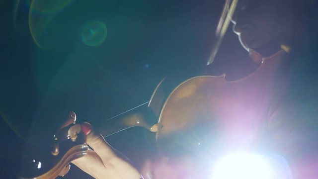 beautiful young girl playing the violin during the concert.close-up