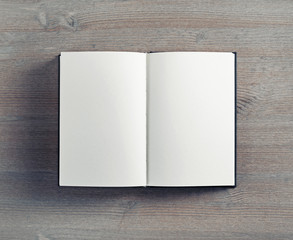 Blank open notepad on vintage wooden background. Flat lay.