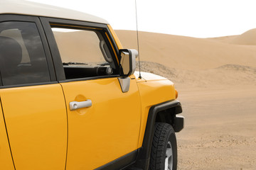 Fototapeta na wymiar Modern car in desert ready for dune bashing