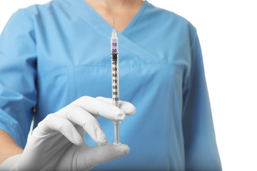 Female doctor with syringe on white background, closeup. Medical object