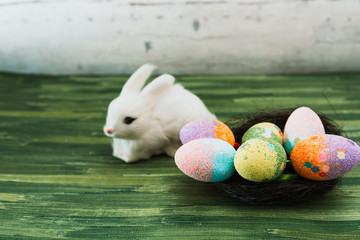 Easter rabbit and eggs with colorful eggs around and white background