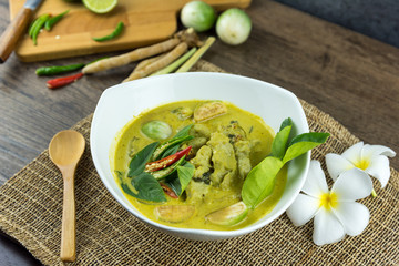 fish ball Green curry with coconut curry (Kaeng kheiyw hwan) on dark wooden background with Thai tradition food served with steamed rice. Thai food very popular