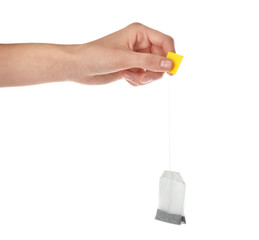Woman holding tea bag on white background