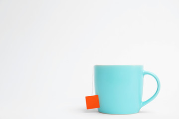 Cup of tasty tea on white background
